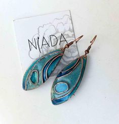 This is a blue cloisonne enamel pendant designed by a hungarian artist, Diana Páthi. Dimensions: The leaf shaped pendants are 5.5 x 2cm + hooks are 1.5cm long. For extra you can order 925sterling silver hooks. Here is the link: https://www.etsy.com/listing/274041444/925-sterling-silver-extra-earring-hooks?ref=shop_home_active_1 Fired cloisonne enamel is a beautiful traditional material for making jewelry. First I cut out the copper pieces, than I form it to a shape I want. After a sandpaper cleaning I put the handformed wire ornaments and I take transparent enamel and colours. During the process I fire the piece at high temperature for three or four times, It depends of the form and the colour I want. I do nearly the same way as ancestors made 4000years before. At the and I clean and polis Blue Enamel Dangle Jewelry, Artisan Blue Nickel-free Earrings, Turquoise Enamel Jewelry Gift, Blue Hand Painted Jewelry Gift, Blue Teardrop Copper Earrings, Blue Hand Painted Jewelry As A Gift, Light Blue Metal Earrings For Gift, Blue Copper Teardrop Earrings, Hand Painted Blue Jewelry For Gifts