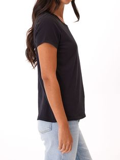 Crafted from 100% organic cotton, this versatile staple piece offers a classic fit and breathability for all-day wear. Elevate your wardrobe with this eco-friendly, must-have addition. Versatile T-shirt With Shirttail Hem, Basic Washed Black Cotton Top, Basic Black Organic Cotton T-shirt, Effortless Stretch Tops For Everyday, Effortless Tops With Shirttail Hem, Effortless Top With Shirttail Hem, Effortless Shirttail Hem Top, Everyday Crew Neck Tops, Washed Black Stretch Cotton Tops