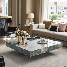 a living room filled with furniture and a large mirror on the wall above it's coffee table