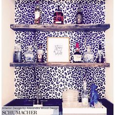 the shelves are decorated with blue and white wallpaper