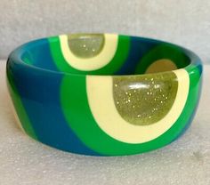 Vintage Lucite Bangle Bracelet 60 Pop Art In Greens & Cream  | eBay Retro Handmade Bangle Jewelry, Handmade Retro Bangle Bracelet, Green Bangle For Collectible Jewelry, Green Bangle Collectible Jewelry, Green Bangle Jewelry Collectible, Mid-century Adjustable Bracelets As Gifts, Mid-century Style Adjustable Bracelets As A Gift, Retro Multicolor Bangle Jewelry, Vintage Multicolor Bangle Bracelets