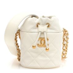 This is an authentic CHANEL Caviar Quilted Twist Your Buttons Mini Bucket Bag in White. This stylish tote is crafted of luxurious diamond quilted caviar calfskin leather in white. This bag features an aged gold leather threaded chain shoulder strap with a leather shoulder pad, aged gold medallion embellishments, and a gold CC logo on the front. The top leather cinch cord opens to a beige fabric interior with a flat pocket. Thread Chains, Mini Bucket Bag, Mini Bucket Bags, Gold Medallion, Mini Bucket, Leather Thread, Chanel Caviar, Beige Fabric, Diamond Quilt