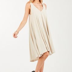 A-Line Midi Dress With Double V-Neck And Tie Back . Model Is 5'8" Bust: 32/B Waist: 24" Hips: 35" Model Is Wearing Size Small Fabric 70% Rayon 30% Linen Made In Made In Usa Beige V-neck Sundress For Day Out, Flowy V-neck Dress For Day Out, Casual Flowy V-neck Sundress, Summer Midi Dress V-neck Unlined, Summer V-neck Unlined Midi Dress, Unlined Summer Midi Dress With V-neck, Unlined V-neck Summer Midi Dress, Flowy V-neck Summer Beach Dress, Casual Beige Midi Dress With V-neck