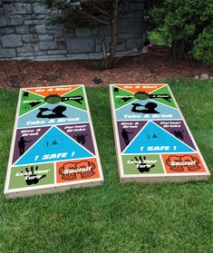 two cornhole boards sitting in the grass