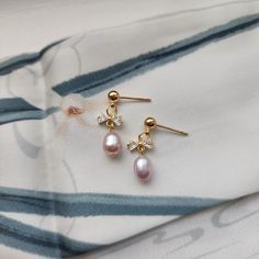 Our cute mini bow pearl earrings are made with natural freshwater pearls, zircon bow knot and 14k gold-plated studs which are good for delicate ears. Size: approx. 0.25" wide and 0.825" long Stud Pearl Earrings, Bow Earring, Earring Pearl, Gift Bow, Pearl Earrings Wedding, Mini Bow, Pearl Dangle Earrings, Mini Bows, Bow Knot