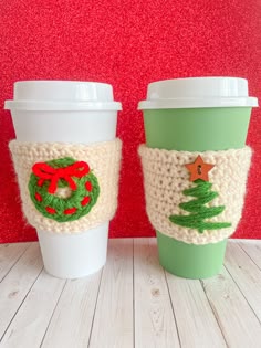 two knitted coffee cups sitting next to each other