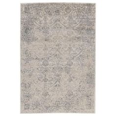 a rug with an ornate design on the front and back side, in grey tones