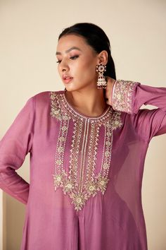 Embrace regal elegance with our Mauve Majesty Zardosi Kurta Set. Adorned with exquisite hand-embroidered zardosi, this set pairs a detailed kurta with sleek slim-fit pants for a modern twist. The luxurious georgette crepe and Tussar silk blend, in a delicate mauve, ensure a graceful drape with a comfortable fit. Designer Wear Elegant Hand Embellished Sets, Elegant Semi-stitched Purple Sets, Elegant Hand Embellished Designer Sets, Elegant Hand Embellished Purple Sets, Festive Hand Embellished Purple Sets, Festive Hand-embellished Purple Sets, Festive Purple Hand Embellished Sets, Elegant Hand Embellished Kurta For Reception, Elegant Hand Embellished Kurta For Wedding