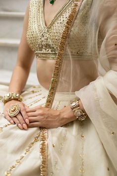 Off white lehenga featuring nakshi and sequins embroidery with an attached cancan. Paired with a padded blouse and a dupatta., Fit: Relaxed Reception Sharara With Tilla Details, Elegant Sleeveless Traditional Wear For Wedding, Wedding Lehenga With Gota Work, Kundan Sharara For Wedding, Fusion Style Lehenga With Traditional Drape For Wedding, Festive Fusion Lehenga For Wedding, Wedding Sets With Gota Work, Fusion Style Fitted Wedding Choli, Fusion Style Wedding Sharara With Dupatta