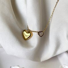 This 2in1 Golden Heart Necklace is perfect for making a statement.  Crafted with 18k gold, it is both dainty and feminine, yet adjustable to enhance your sophisticated style.  Its waterproof, hypoallergenic, and anti-tarnish components guarantee a timeless and classy look that you can enjoy for years to come. ☆Waterproof gold necklace ☆Hypoallergenic necklace ☆Anti tarnish ☆40cm + 5cm extension for extra comfort and styling ✨ABOUT CRESCENT JEWELRY DESIGNS All jewelry is made by Crescent Jewelry Designs in the heart of Nashville Tennessee. Designing unique and beautiful jewelry is our passion, and our goal is to make sure you are 100% satisfied with the products. Each piece is made with hypoallergenic earring posts and free from lead and nickel. If you have any questions or concerns regardi Gold Locket Necklace With Clavicle Chain As Gift, Minimalist Gold Chain Necklace With Heart Charm, Minimalist Gold Heart Pendant Charm Necklace, Gold Stainless Steel Heart Necklace With Adjustable Chain, Minimalist Gold Heart Necklace With Clavicle Chain, Gold Dainty Heart Necklace In Stainless Steel, Minimalist Double Heart Clavicle Chain Jewelry, Dainty Gold Stainless Steel Heart Necklace, Delicate Gold Double Heart Charm Necklaces