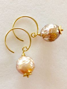 "Soft peach glow Chinese freshwater Kasumi pearls wire wrapped on handmade 24k gold vermeil ear wires Beautiful 11mm Chinese kasumi pearls with characteristic iridescent bumpy surface are full of color and texture and highly lustrous. They display a full array of metallic colors including dusty rose pink, peach and bronze. Stunning kasumi pearls are wire wrapped on 24k gold vermeil handmade ear wires with tiny gold vermeil wavy disc accents. Total length is 1 1/4\". Also in Sterling silver." Handmade Delicate Pearl Earrings, Wire Wrapped Round Pearl Jewelry, Handmade Baroque Pearl Round Jewelry, Handmade Baroque Pearl Jewelry, Handmade Pear-shaped Pearl Jewelry, Handmade Adjustable Pearl Earrings, Handmade Delicate Baroque Pearl Earrings, Delicate Handmade Gold Pearl Earrings, Handmade Baroque Pearl Pear-shaped Earrings