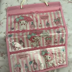 a pink hello kitty suitcase on a bed