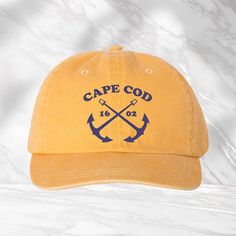 "Cape Cod 1602 Hat, Cape Cod Hat, Massachusetts Cap, Vacation Hat, Cape Cod Souvenir Cap, Summer Hat, Beach Hat, Embroidered Hat We use DTF Vinyl Heat Pressed Design. Mega Cap - Pigment Dyed Cotton Twill Cap - 7601A - 100% cotton pigment dyed twill - Unstructured, six-panel, low profile - Self-fabric sweatband and six sewn eyelets - Self-fabric strap with brass snap buckle and sewn grommet - Adult Sizing: 6 5/8\" - 7 3/8\"" Curved Brim Hat With Embroidered Logo For Vacation, Beach Dad Hat With Flat Brim, Beach Dad Hat With Flat Bill, Yellow Cap For Vacation, Yellow Curved Brim Hats With Letter Print, Yellow Hats With Letter Print And Curved Brim, Vintage Baseball Cap With Curved Brim For Beach, Vintage Curved Brim Baseball Cap For Beach, Yellow Vacation Cap