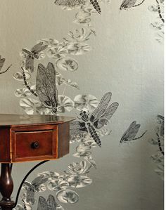 the wallpaper is decorated with dragonflies and flowers