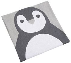 a grey and white rug with a black penguin on it's face, in front of a white background