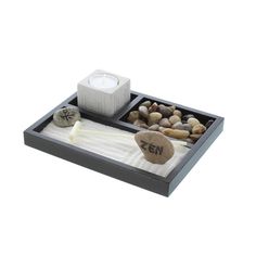 a tray with rocks and candles on it