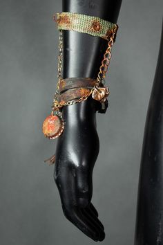 A simple and stylish bracelet, consisting of two pieces connected with chains: a leather string and an upcycled army strap. This jewelry piece is made by hand, from recycled materials. It has a nice rusty finish and dangling charms with a bottlecap and a leather tassel. It's a great eye-catching detail that will add a bling to your festival costume! All of our clothes are handmade, which is why individual pieces may slightly differ from those shown in the photos. If you can't find your size or would like to customize this product according to your preferences, please don't hesitate to contact us. MORE APOCALYPTIC CLOTHES AND ACCESSORIES AT: https://www.etsy.com/shop/WastedCouture ------------------------------ Wasted Couture - WastedCouture Wear if you dare! Adjustable Metal Punk Chain Bracelet, Adjustable Metal Chain Bracelet, Punk Style, Punk Style Brown Jewelry For Gift, Punk Style Metal Bracelets, Punk Style Metal Bracelet Strap Jewelry, Punk Metal Jewelry With Bracelet Strap, Punk Style Metal Bracelet, Adjustable Metal Wristband Fashion Accessory, Adjustable Metal Wristband