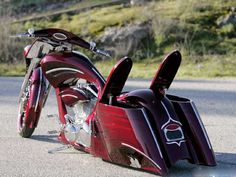 a red motorcycle parked on the side of a road