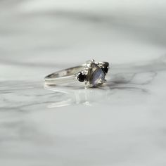 A classic cut, the pear-shaped Sienna ring with side Moissanite is the ultimate ring to gift a loved one. It is a timeless piece that can always be paired with other nesting bands to elevate your look.  A ring that will never disappoint, and makes the perfect pre-engagement ring or promise ring for a friend. Details: C Elegant Teardrop Moonstone Promise Ring, Timeless Moonstone Promise Ring, Timeless Teardrop Ring As A Gift, Classic Teardrop Gemstone Rings, Fine Jewelry Three Stone Teardrop, Timeless Pear-shaped Ring As A Gift, Elegant Teardrop Moonstone Ring For Anniversary, Teardrop Three Stone Jewelry For Gifts, Teardrop Three Stone Jewelry Gift