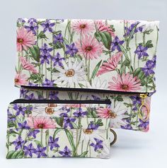 Elevate your spring and summer style with the Blossom Foldover Clutch Bag and matching wallet. The perfect accessories to complement any warm-weather ensemble. These pieces feature a delicate floral motif that exudes elegance and femininity. The clutch's versatile foldover design allows for an effortless transition from day to night. There is plenty of space with the front pocket and the deep interior. The bag's dimensions are 13" (open) Tall x 9 3/4" Wide x 3/4" Thick.  This matching, stylish, handmade wallet fits perfectly inside the external pocket or bag. It has six slots for your credit cards, a pouch for your cash, and coins with a matching black zipper. You can remove the wallet and use it in any other bag. Wallet dimensions: 6 3/4 long x 3 3/4 wide. Spring Rectangular Bags With Interior Card Slots, Spring Travel Pouch With Rectangular Shape, Spring Travel Bags With Interior Card Slots, Rectangular Travel Pouch For Spring, Spring Travel Rectangular Pouch, Travel Clutch Pouch For Spring, Trendy Spring Wallets Perfect For Gifts, Spring Zipper Pouch Wallet, Rectangular Pink Pouch For Spring