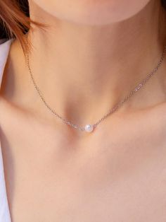 The minimalist pearl pendant necklace is the epitome of refined elegance. Its delicate design features a 6 mm white natural pearl set on a silver-tone anchor chain. Weighing just 1.7 grams (0.06 oz), the necklace measures 37 cm (14.5 inches) with an additional 7 cm (2.7 inches) extender for versatile styling. Made of durable silver-tone brass with a secure lobster clasp, this necklace blends simplicity with subtle sophistication. Perfect for daily wear or formal occasions, the natural pearl symbolizes purity, harmony, and femininity, making it a timeless wardrobe essential. Pearl Silver Necklace, Pearl Necklace Wedding, Anchor Chain, Silver Pearl Necklace, Dainty Pendant, Baroque Pearl Necklace, Necklace Delicate, Pendant With Chain, Necklace Wedding