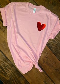 Simple and Subtle way to express your LOVE on Vday. Makes for great gift for her.. Moms, daughters, girlfriends or just yourself! Soft and comfy UNISEX T-shirt soft pink 50/50 cotton/poly 3.5x3.5 metallic red heart Available in infant, toddler, yths and adults sizes. Heat pressed with high quality siser htv and professional pressed. LAST DAY TO ORDER TO RECEIVE NORMAL MAIL IS 2/10/19. Vday Gift Ideas, Womens Valentine Shirts, Heart Tshirt, Vday Gifts, Football Mom Shirts, Valentines Day Shirt, Valentine Shirt, Pink Valentines, Valentine's Day Outfit