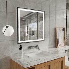 a bathroom with marble counter tops and a large mirror over the sink in front of it