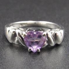 a heart shaped amethorate ring with leaves on it