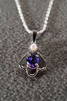 I am offering you this truly exquisite vintage unique genuine combination round and oval shaped prong set African amethyst and cultured pearl stones done in a dimensional curved scrolled design shaped , on a necklace chain. What a spectacular design.... So very elegant and a very fancy ornate setting. It is measuring a bit under 1 inch by app. 1/2 inch, you will be noticed when wearing this lavaliere necklace. The necklace chain is a very sturdy rolled rope link chain that measures a very versat White Gold Oval Pearl Pendant Jewelry, Classic Oval Amethyst Necklaces, Purple Oval Jewelry For Formal Occasions, Oval Pearl Pendant Jewelry, Fine Jewelry Amethyst Oval Pendant, Elegant Purple Oval Pendant Necklace, Vintage Purple Teardrop Jewelry, Oval Amethyst Birthstone Necklaces, Vintage Purple Oval Cabochon Jewelry