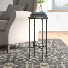 a living room with a couch, chair and side table on the carpeted floor