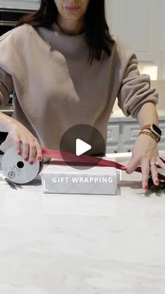 a woman sitting at a kitchen counter with a knife in her hand and the words get wrapping written on it