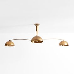 three brass colored lights hang from the ceiling