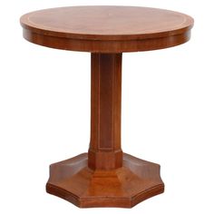 a round wooden table with two pedestals