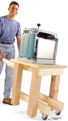 a man standing next to a table with a toaster on it's side