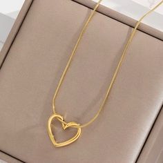 Mini Hollow Twist Heart Pendant Necklace – 18K Gold Plated Stainless Steel Chain for Women and Girls Discover the charm of our Mini Hollow Twist Heart Pendant Necklace. This elegant piece features a delicate heart pendant with a unique twist design, plated in 18K gold on a durable stainless steel chain. Perfect for women and girls who adore minimalist and aesthetic jewelry, this necklace is a standout accessory for any occasion. Ideal for enhancing your everyday look or adding a touch of sophist Gold Snake Chain Necklace For Valentine's Day, Gold Snake Chain Necklaces For Valentine's Day, Gold Plated Tarnish Resistant Heart Necklace For Mother's Day, Mother's Day Double Heart Gold Plated Necklace, Gold Snake Chain Jewelry For Valentine's Day, Gold Plated Double Heart Necklace, Tarnish Resistant, Elegant Gold-tone Charm Necklaces For Valentine's Day, Elegant Gold-tone Charm Necklace For Valentine's Day, Gold Plated Tarnish Resistant Double Heart Necklace