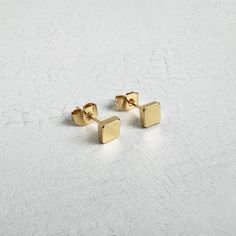 Simple and sophisticated, our geometric stud earrings are beautifully plated in 18k gold and perfect for everyday wear. · 18k gold plated brass · Push back closure · 5x5mm Modern Gold Plated Plug Earrings As Gift, Modern Gold Plated Plug Earrings For Gift, Modern Gold-plated Plug Earrings As Gift, Minimalist 14k Gold Rectangular Earrings, Minimalist Gold Plug Earrings As Gift, Minimalist Yellow Gold Drop Plug Earrings, Modern Gold Hypoallergenic Plug Earrings, Minimalist Tarnish Resistant Plug Earrings Gift, Minimalist Square Hypoallergenic Earrings