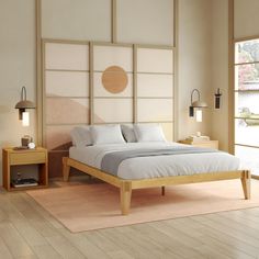 a large bed sitting on top of a hard wood floor next to a wooden table