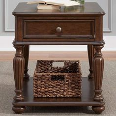 an end table with a basket underneath it and a book on the shelf next to it