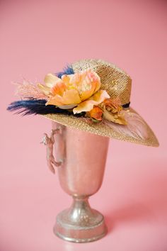 Stay ahead of the pack with THE FRONT RUNNER SUN HAT! The derby style will make you feel like a real winner while the navy feather and orange flower add a pop of color. Keep cool and fashionable with this must-have accessory. This hat is ONE OF A KIND, created by our owner Stephanie. To receive item quicker, expedited shipping is available at checkout. Summer Costume Hats With Feathers And Short Brim, Feathered Brimmed Hat Bands For Summer, Brimmed Hat Bands With Feathers For Summer, Summer Mini Hats With Feathers And Curved Brim, Feathered Hat Bands For Beach Events In Summer, Summer Mini Hat With Curved Brim And Feathers, Feather Hat Bands For Country Events In Summer, Feathered Hat Bands For Country Events In Summer, Kentucky Derby Mini Hat For Country Events