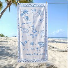 a towel hanging from a clothes line on a beach with palm trees in the background