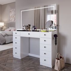 a bedroom with a large mirror and white dresser in it's center, next to a bed that has a handbag on the floor