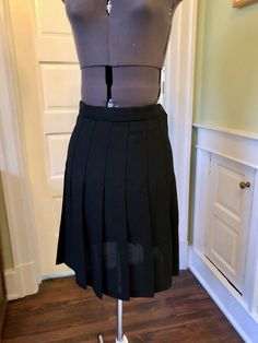 This easy care classic is great for petites with its' shorter length. This skirt is made of 100% polyester black crepe fabric. It is unlined. It features a waistband with side zipper and button closure, and permanent pleats. This garment is clean, with no stains or snags. Measurements to guide you: Waist: 26-27" Hip: 44" Length: 21" Decade: Fabric: Polyester Crepe Size: S Condition: Great Brand: Wheaton & Katz Ltd. It's a delight to pick through time for you to find these vintage treasures. Formal Fitted Mini Skirt With Accordion Pleats, Classic Fitted A-line Skirt, Fitted Accordion Pleats Mini Skirt For Work, Classic Fitted A-line Bottoms, Fitted Mini Skirt With Pleated Hem For Work, Classic Fitted Mini Skirt With Pleated Waist, Fitted Knee-length Pleated Skort, Formal Fitted Skirt With Box Pleats, Black Accordion Pleats Mini Skirt For Work