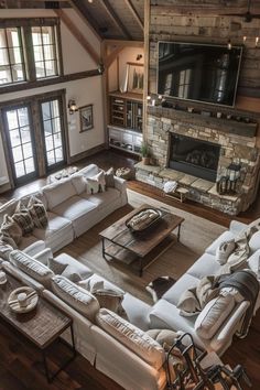 a large living room with white couches and a fireplace