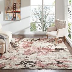 a living room with a large rug and two white chairs in front of a window