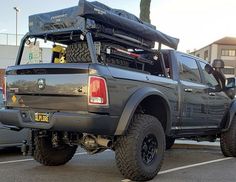 the truck is parked in the parking lot with its roof rack on it's back