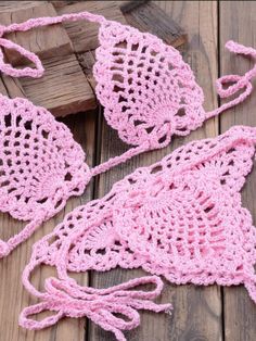 pink crocheted bags on wooden planks