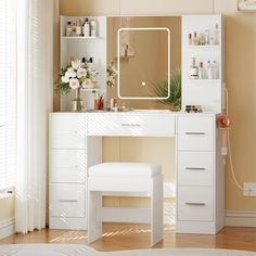 a white vanity table with a mirror and stool in front of it on a hard wood floor