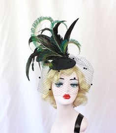 Black Feather Fascinator with Dotted Veil, Showgirl Peacock Headpiece, High Fashion Hat, Ascot Races, Kentucky Derby, Halloween Wedding This hat is huge and fantastic. It is made from a sturdy hand blocked buckram base (I use two layers of buckram) that has been wired and then covered in felt and then covered in a black brushed satin. A spray of huge black iridescent coquille feathers and perfectly curled peacock swords set on top of this perfectly you can wear it on either side of your head for Vintage Fitted Costume Hats And Headpieces For Carnival, Vintage Fitted Costume Hats For Carnival, Adjustable Fascinator For Costume Carnival, Adjustable Fascinator For Carnival Costume, Fitted Gatsby Mini Hats For Vintage Events, Vintage Fitted Hat For Costume Party, Vintage Mini Hats With Feathers For Party, Fitted Fascinator For Costume Occasions, Retro Fitted Fascinator For Kentucky Derby