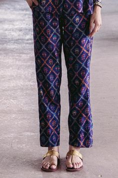 Midnight blue shirt featuring floral print, embroidered cuffs, and a button placket. Paired with printed trousers in a matching design., Fit: Relaxed Silk Workwear Sets With Printed Motifs, Silk Sets With Printed Motifs For Workwear, Traditional Floral Print Festive Bottoms, Traditional Floral Print Festive Pants, Festive Pants With Printed Motifs, Festive Floral Print Pants, Spring Festive Pants With Printed Motifs, Traditional Spring Pants With Printed Motifs, Silk Straight Pants For Festive Occasions