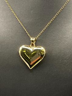 Designed and crafted in 14 karat solid yellow gold.  This classically designed puffed heart pendant looks beautiful worn on your favorite chain.   Weight:  1.5 grams  Length:  1" Width: ⅞" Our Price $219.00 Regularly Priced At $425.00 Please See Our Video Remember - If you're purchasing for yourself or a gift for a loved one, buy with confidence.  We Guarantee Everything We Sell!  SKU # P647 Formal Heart Charm Jewelry With Heart Pendant, Formal Heart Pendant Jewelry With Heart Charm, Classic 14k Gold Heart-shaped Jewelry, Classic 14k Gold Heart Jewelry, Classic Yellow Gold Heart Necklace As Gift, Classic Heart-shaped 14k Gold Jewelry, Classic Yellow Gold Heart Necklace For Gift, Formal Polished Heart Pendant Necklace, Gold Heart Pendant Necklaces For Formal Occasions